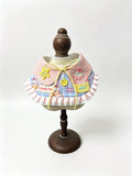 Pink gingham ruffle bib with cupcake patch