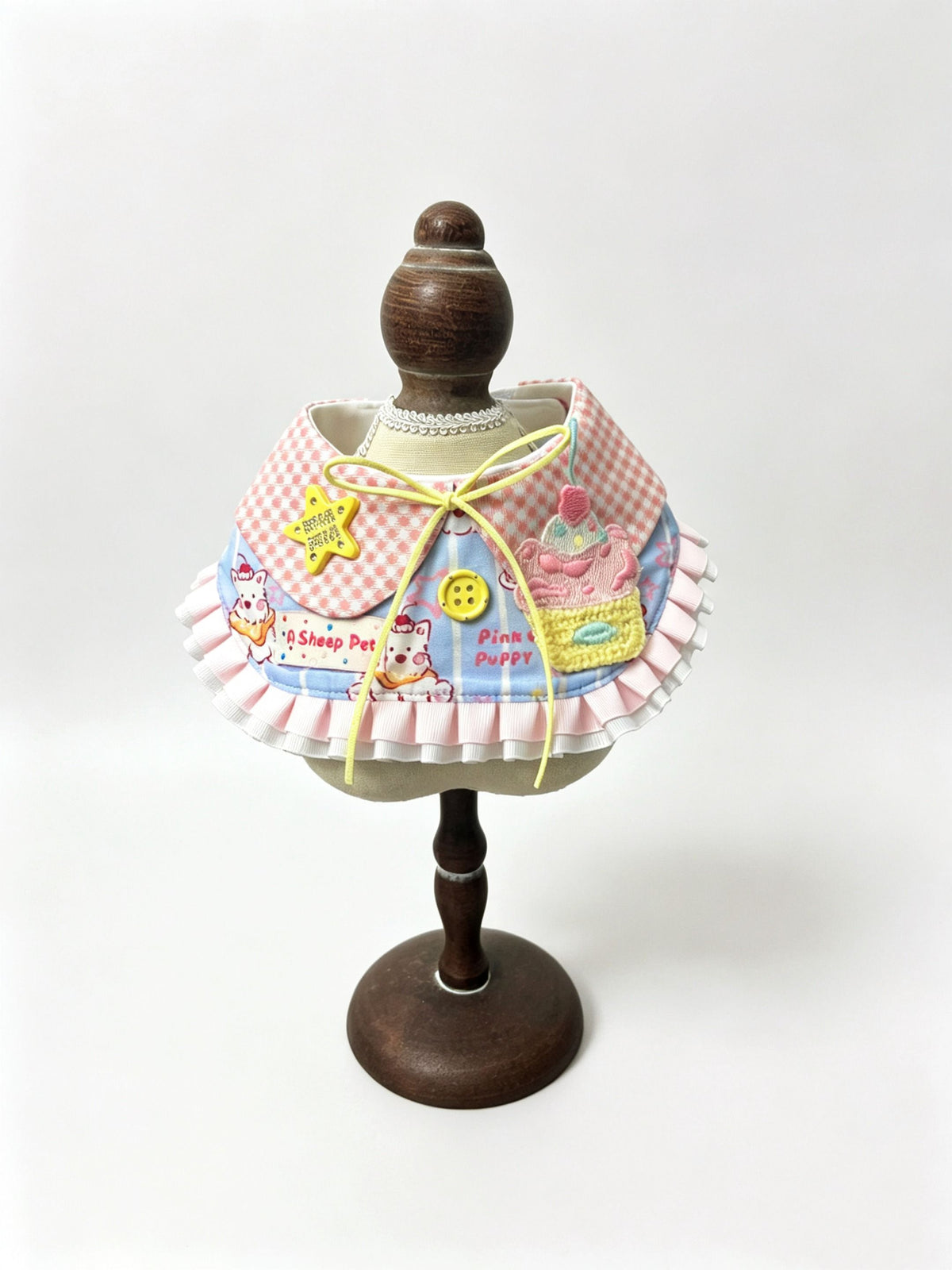 Pink gingham ruffle bib with cupcake patch